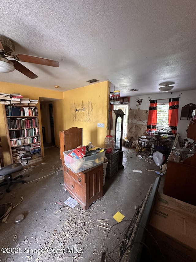 2793 N Breeze Rd, Melbourne, FL 32935 - living area with a textured ceiling and a ceiling fan
