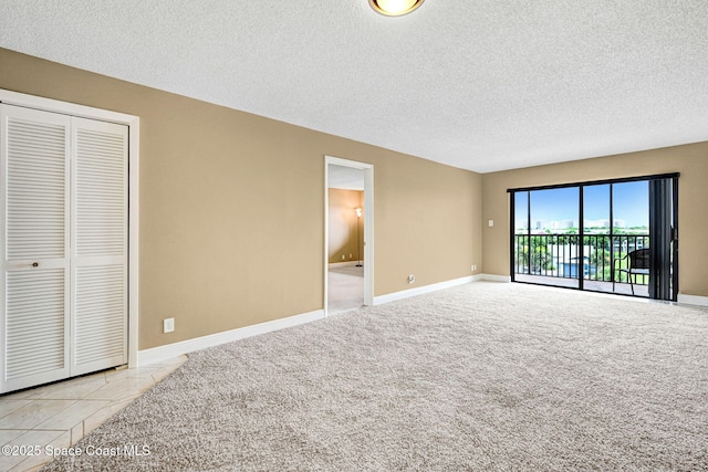520 Palm Springs Blvd Unit 405, Indian Harbour Beach, FL 32937 - unfurnished living room featuring a textured ceiling and light carpet