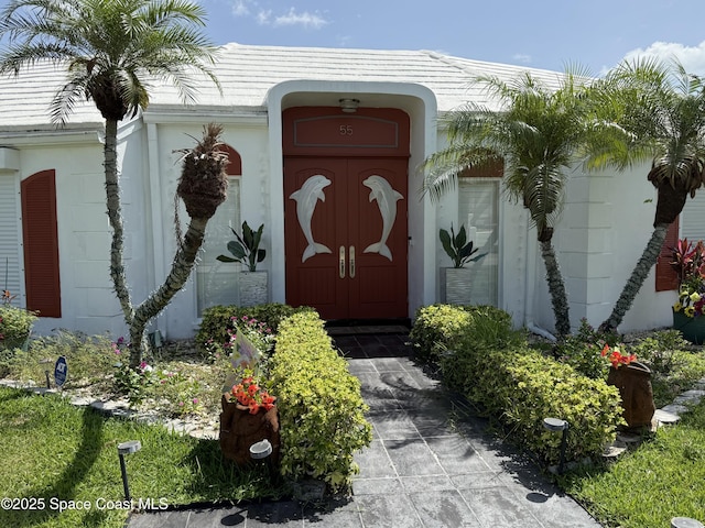 55 Country Club Rd, Cocoa Beach, FL 32931 - property entrance featuring stucco siding