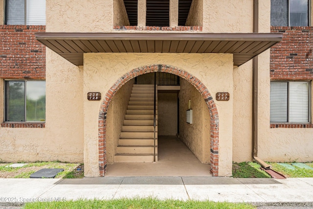 128 San Paulo Cir Unit 128, West Melbourne, FL 32904 - doorway to property featuring stucco siding