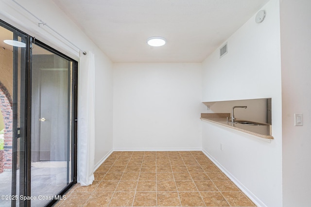 128 San Paulo Cir Unit 128, West Melbourne, FL 32904 - empty room featuring a sink and a smoke detector