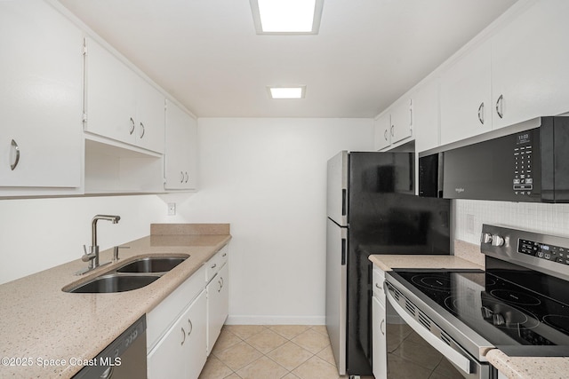 128 San Paulo Cir Unit 128, West Melbourne, FL 32904 - kitchen with stainless steel electric stove, white cabinetry, light tile patterned flooring, and decorative backsplash