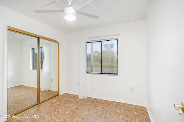 128 San Paulo Cir Unit 128, West Melbourne, FL 32904 - unfurnished bedroom featuring a closet, ceiling fan, and light tile patterned floors