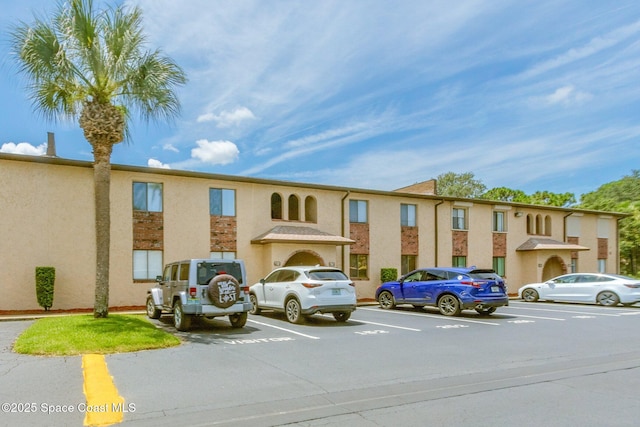 128 San Paulo Cir Unit 128, West Melbourne, FL 32904 - view of property featuring uncovered parking