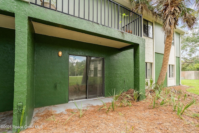 2219 Flower Tree Cir, Melbourne, FL 32935 - doorway to property with a balcony and stucco siding