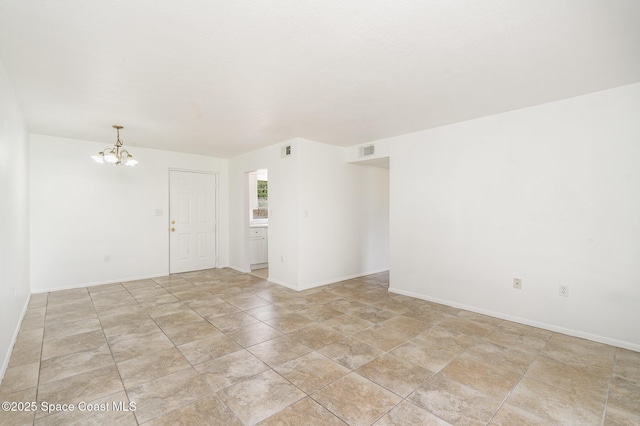 2219 Flower Tree Cir, Melbourne, FL 32935 - unfurnished room with a chandelier and baseboards
