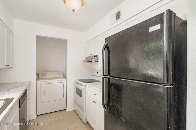 2219 Flower Tree Cir, Melbourne, FL 32935 - laundry area with washer / clothes dryer and light tile patterned floors