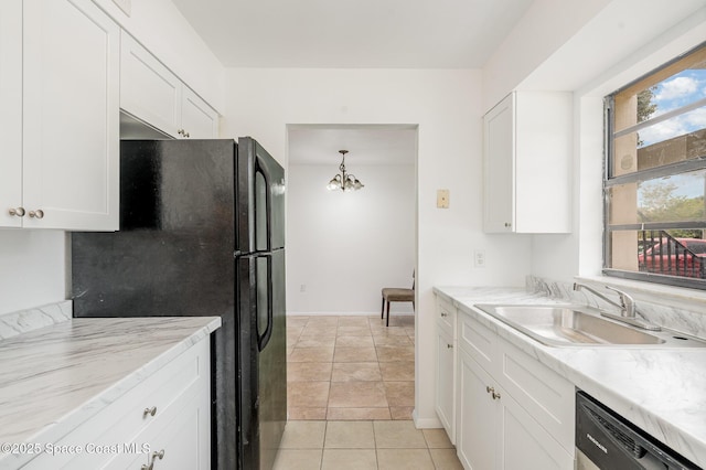 2219 Flower Tree Cir, Melbourne, FL 32935 - kitchen featuring dishwashing machine, freestanding refrigerator, white cabinetry, and a chandelier