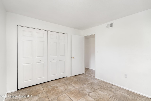 2219 Flower Tree Cir, Melbourne, FL 32935 - unfurnished bedroom with baseboards and a closet
