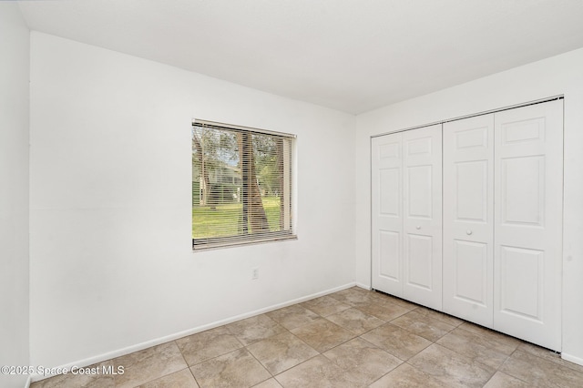 2219 Flower Tree Cir, Melbourne, FL 32935 - unfurnished bedroom featuring baseboards and a closet