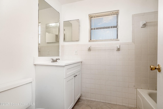 2219 Flower Tree Cir, Melbourne, FL 32935 - full bath featuring tile walls, tile patterned floors, vanity, wainscoting, and shower / bath combination