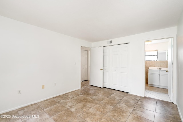 2219 Flower Tree Cir, Melbourne, FL 32935 - unfurnished bedroom with a closet and ensuite bathroom