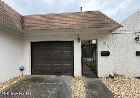 2794 Demaret Dr Unit 604, Titusville, FL 32780 - garage featuring driveway