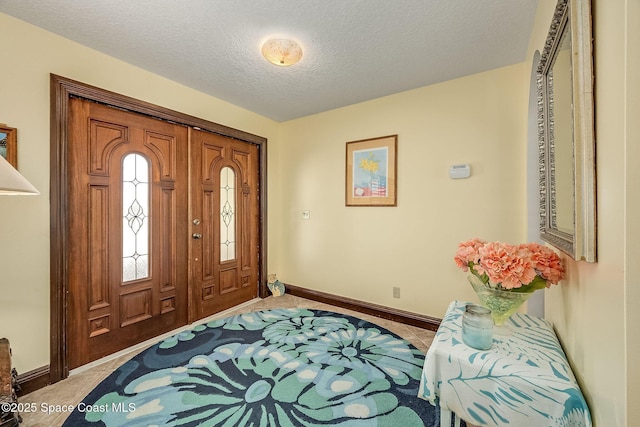 63 Yacht Haven Dr, Cocoa Beach, FL 32931 - foyer with baseboards and a textured ceiling