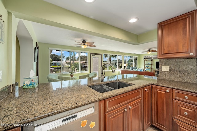 63 Yacht Haven Dr, Cocoa Beach, FL 32931 - kitchen with ceiling fan, stainless steel dishwasher, open floor plan, dark stone counters, and recessed lighting