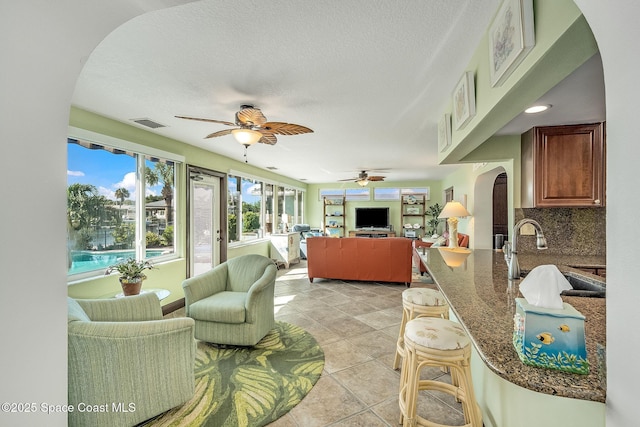 63 Yacht Haven Dr, Cocoa Beach, FL 32931 - sunroom with arched walkways and a sink