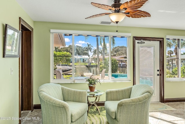 63 Yacht Haven Dr, Cocoa Beach, FL 32931 - sitting room featuring a ceiling fan and healthy amount of natural light