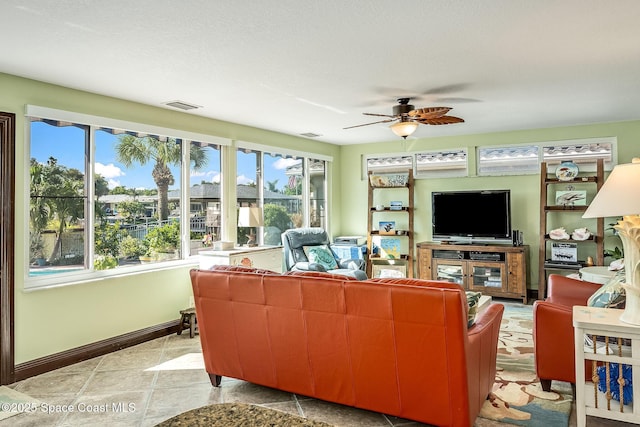 63 Yacht Haven Dr, Cocoa Beach, FL 32931 - living area featuring a ceiling fan and baseboards