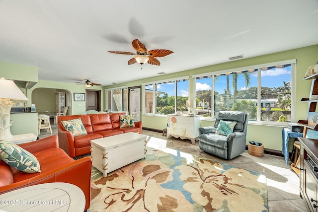 63 Yacht Haven Dr, Cocoa Beach, FL 32931 - tiled living area featuring a ceiling fan and arched walkways