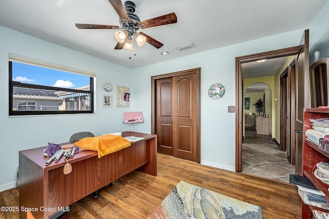 63 Yacht Haven Dr, Cocoa Beach, FL 32931 - home office with arched walkways, a ceiling fan, wood finished floors, a textured ceiling, and recessed lighting