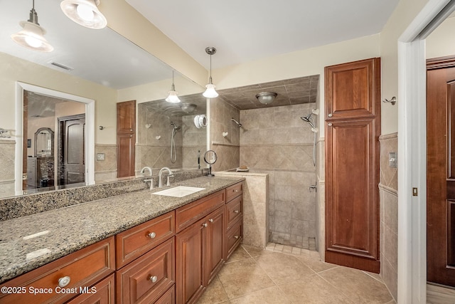 63 Yacht Haven Dr, Cocoa Beach, FL 32931 - full bath featuring tile walls, vanity, tile patterned flooring, and a tile shower