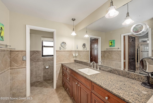 63 Yacht Haven Dr, Cocoa Beach, FL 32931 - full bath with tile walls, tile patterned flooring, vanity, and a wainscoted wall