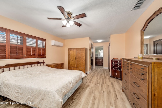 63 Yacht Haven Dr, Cocoa Beach, FL 32931 - bedroom featuring a wall mounted air conditioner, light wood-style floors, multiple windows, and connected bathroom
