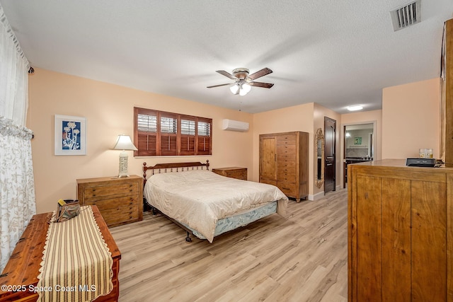 63 Yacht Haven Dr, Cocoa Beach, FL 32931 - bedroom with an AC wall unit, light wood-style floors, and ceiling fan