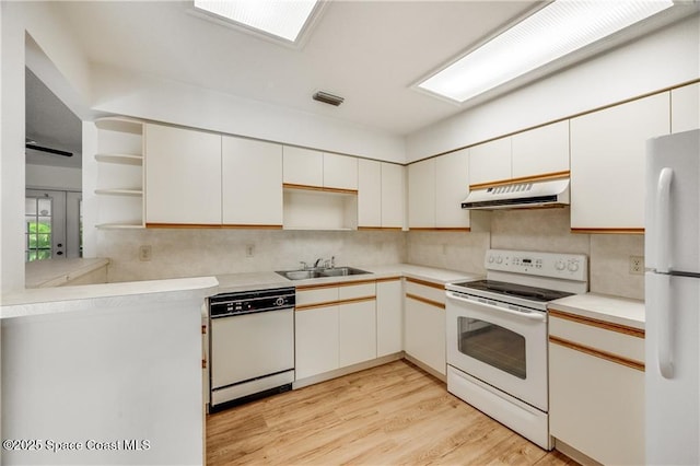 1020 Seamist Ln, Sebastian, FL 32958 - kitchen featuring white appliances, open shelves, range hood, and decorative backsplash