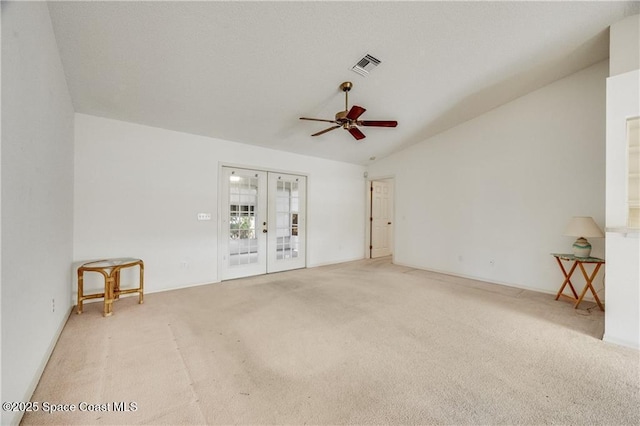1020 Seamist Ln, Sebastian, FL 32958 - empty room with french doors, carpet flooring, ceiling fan, and vaulted ceiling