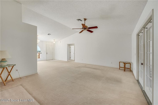 1020 Seamist Ln, Sebastian, FL 32958 - unfurnished living room featuring lofted ceiling, light carpet, a ceiling fan, a textured ceiling, and french doors