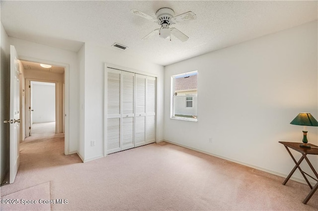 1020 Seamist Ln, Sebastian, FL 32958 - unfurnished bedroom featuring carpet, a closet, ceiling fan, and a textured ceiling