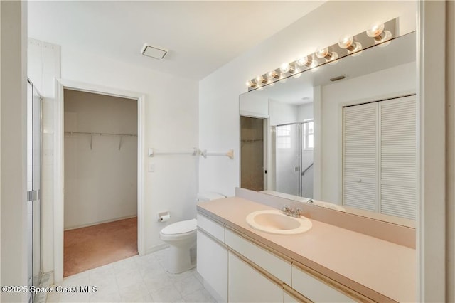 1020 Seamist Ln, Sebastian, FL 32958 - bathroom with vanity, a stall shower, and a walk in closet