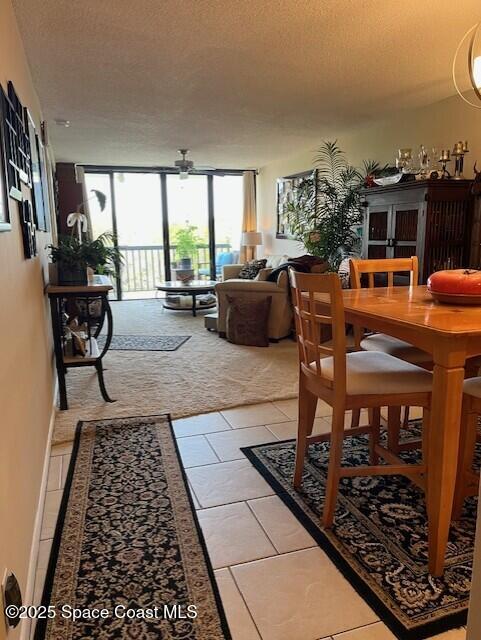 300 Columbia Dr Unit 206-1, Cape Canaveral, FL 32920 - living room with a textured ceiling, a ceiling fan, and light tile patterned floors