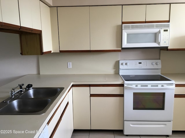 300 Columbia Dr Unit 206-1, Cape Canaveral, FL 32920 - kitchen featuring white appliances, light countertops, and white cabinets