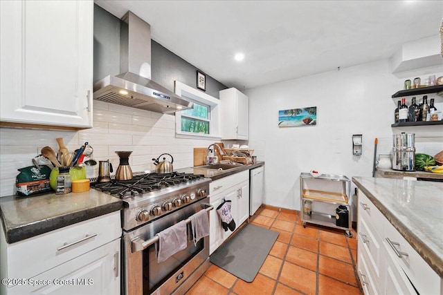 2314 Post Rd, Melbourne, FL 32935 - kitchen featuring high end stove, wall chimney exhaust hood, backsplash, dishwasher, and white cabinetry