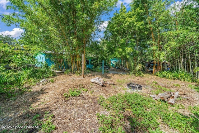 2314 Post Rd, Melbourne, FL 32935 - view of yard featuring an outdoor fire pit