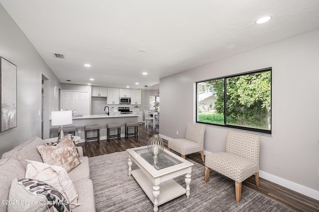 127 Friar Ct, Sebastian, FL 32958 - living room featuring dark wood-style flooring and recessed lighting