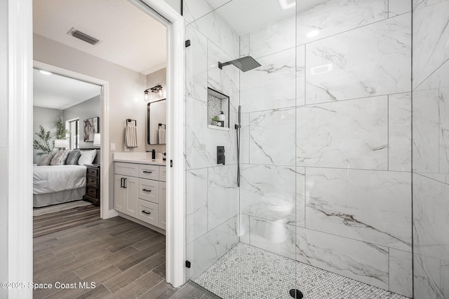 127 Friar Ct, Sebastian, FL 32958 - full bathroom with a marble finish shower, vanity, wood finished floors, and ensuite bathroom