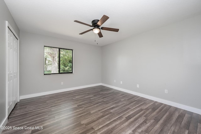 127 Friar Ct, Sebastian, FL 32958 - unfurnished bedroom with dark wood-style floors, a closet, and a ceiling fan