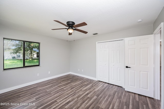 127 Friar Ct, Sebastian, FL 32958 - unfurnished bedroom with dark wood finished floors, a closet, and a ceiling fan