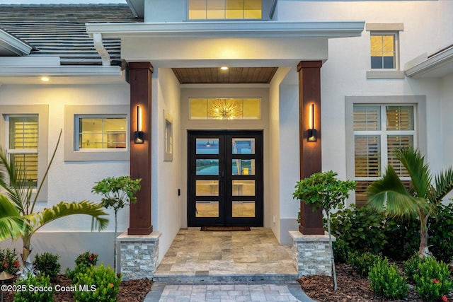3778 Lake Adelaide Pl, Rockledge, FL 32955 - property entrance with stucco siding, a porch, and french doors
