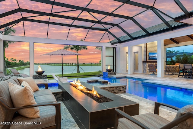 3778 Lake Adelaide Pl, Rockledge, FL 32955 - pool at dusk with a patio, exterior bar, glass enclosure, and an outdoor living space with a fire pit