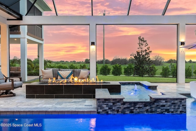 3778 Lake Adelaide Pl, Rockledge, FL 32955 - pool at dusk featuring an outdoor living space with a fire pit, a patio, and an outdoor pool