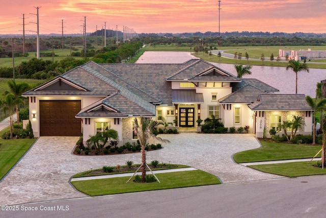 3778 Lake Adelaide Pl, Rockledge, FL 32955 - view of front of property with curved driveway, stucco siding, french doors, a front lawn, and a garage