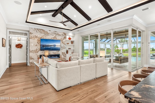 3778 Lake Adelaide Pl, Rockledge, FL 32955 - living area featuring a ceiling fan, light wood-style flooring, crown molding, a premium fireplace, and built in shelves