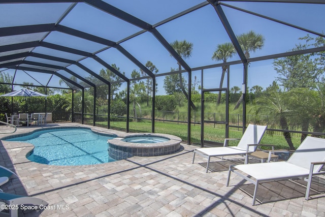 5082 Monroe Cir, Vero Beach, FL 32967 - view of pool featuring a patio, a pool with connected hot tub, and glass enclosure