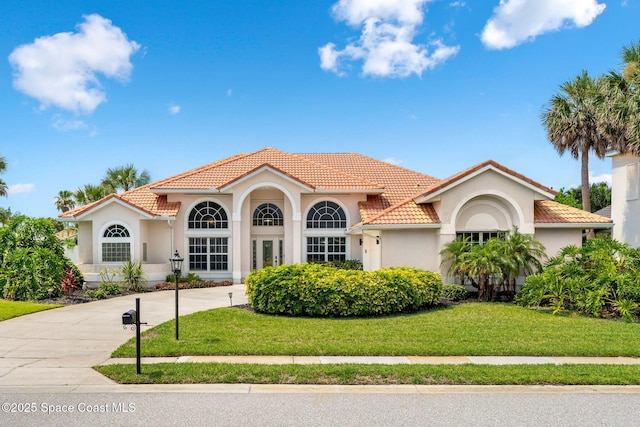 227 Loggerhead Dr, Melbourne Beach, FL 32951 - mediterranean / spanish-style house with stucco siding, a front yard, and a tiled roof