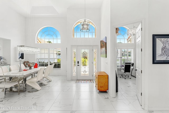 227 Loggerhead Dr, Melbourne Beach, FL 32951 - entryway with a chandelier, a towering ceiling, and marble finish floors