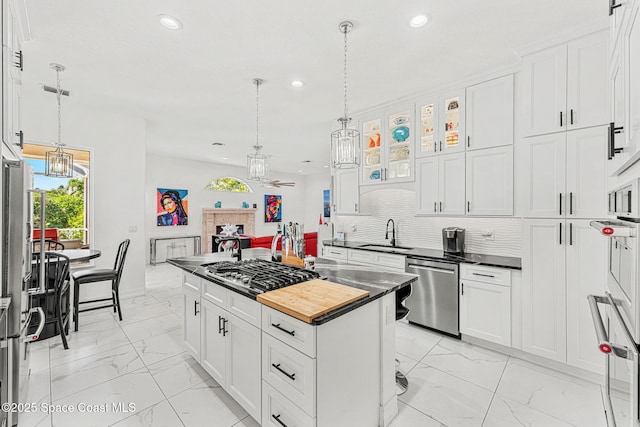 227 Loggerhead Dr, Melbourne Beach, FL 32951 - kitchen featuring light marble finish floors, a chandelier, recessed lighting, white cabinetry, and appliances with stainless steel finishes